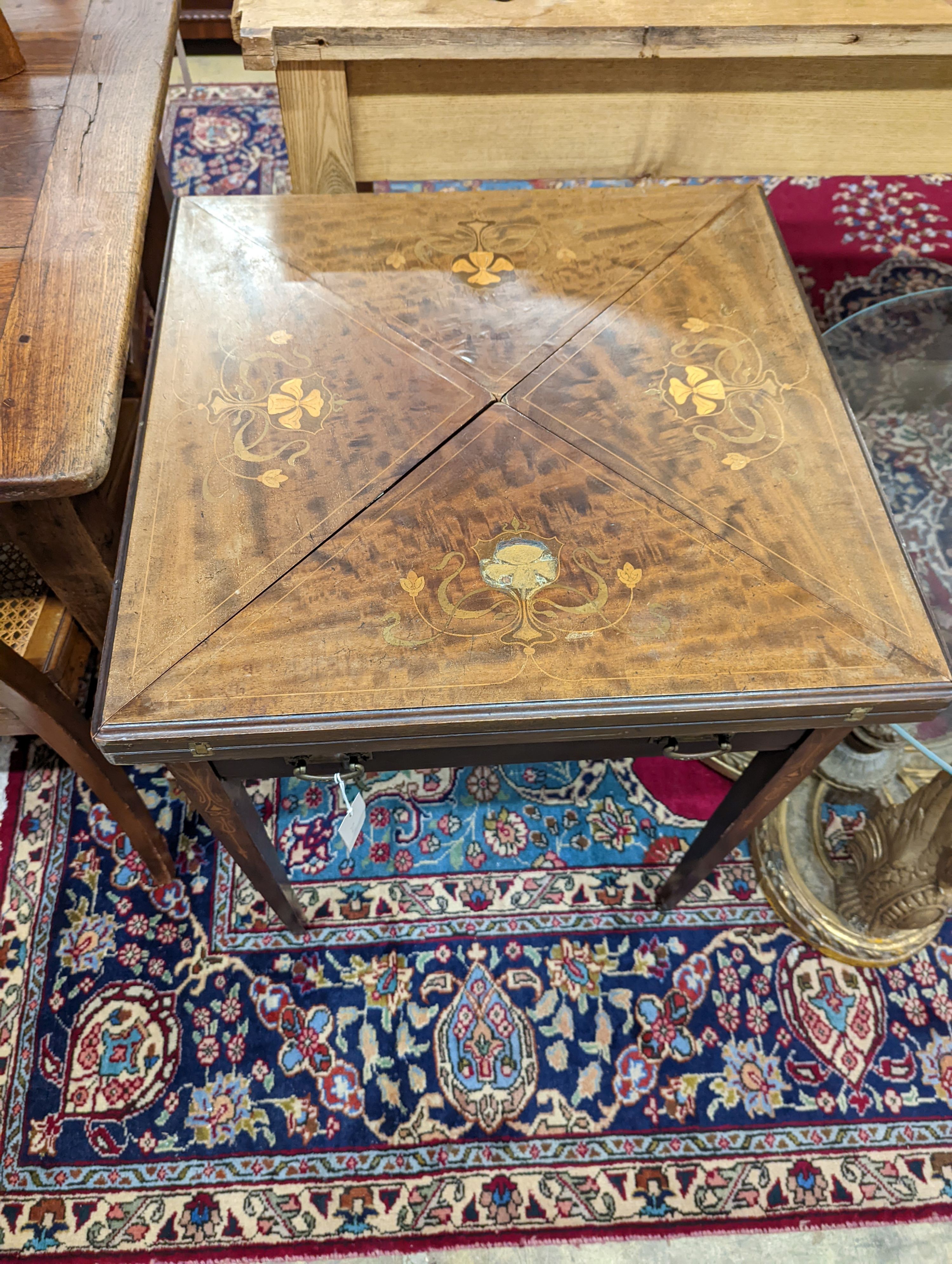 An Edwardian Art Nouveau mahogany and marquetry envelope card table. W-56, D-56cm, H-73cm.